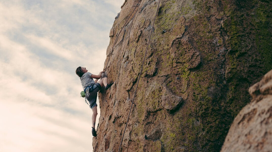 person climbing mountain