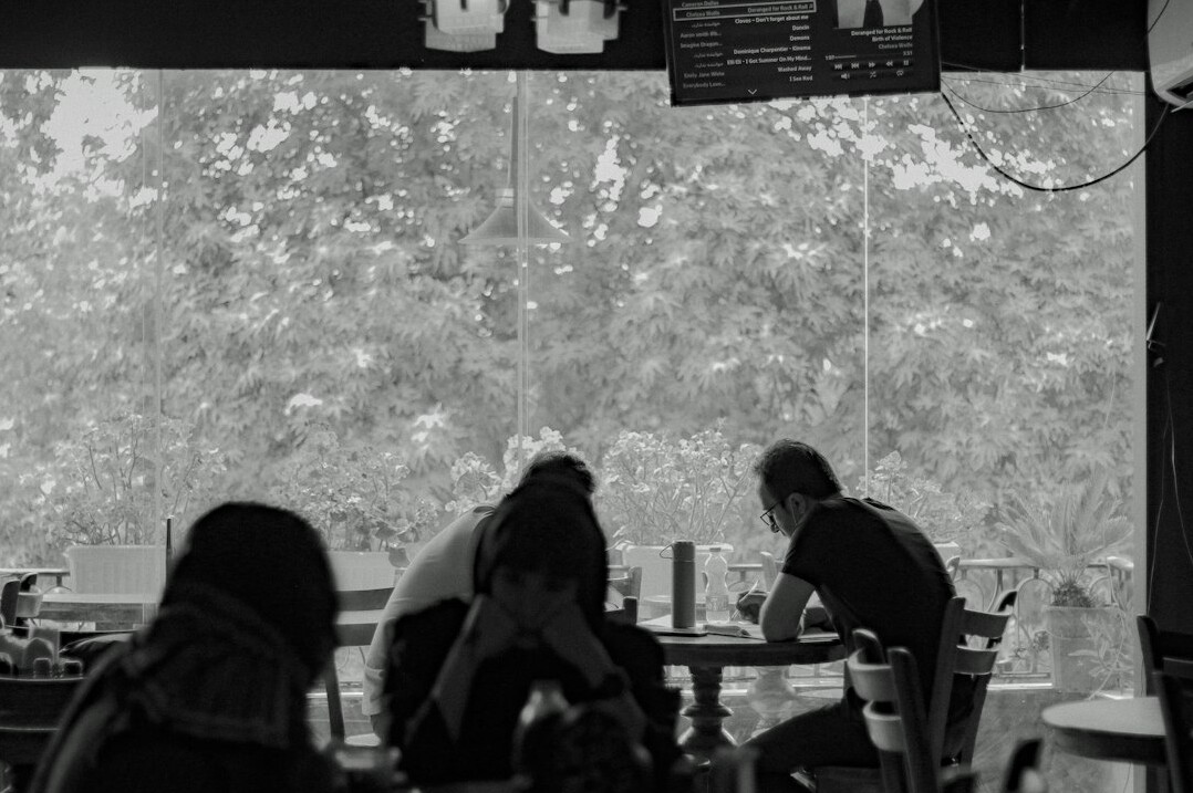 Friends talking over coffee in a cafe