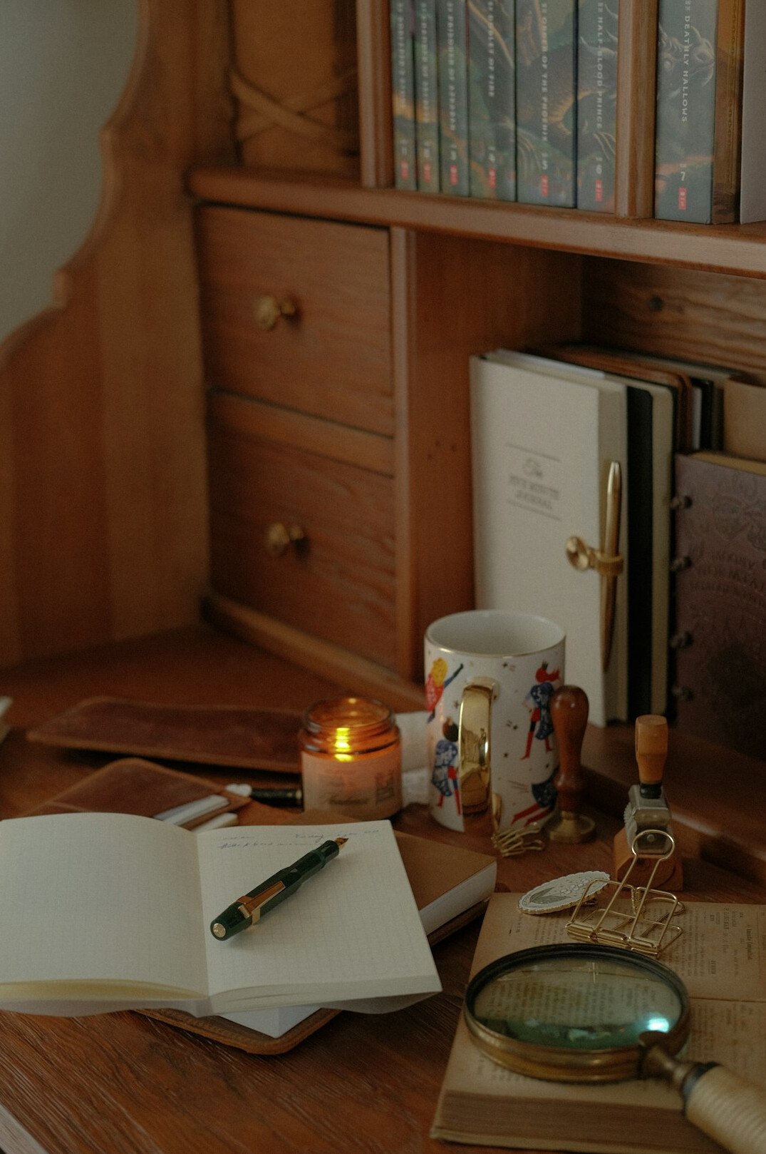 person writing in journal at desk