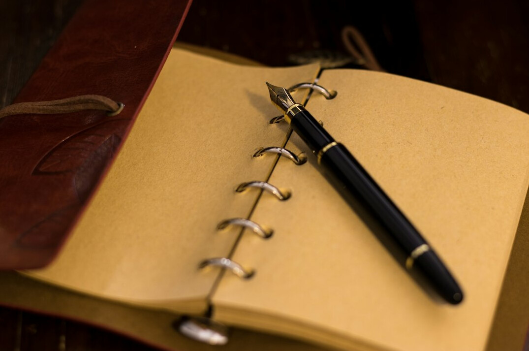 open journal with pen